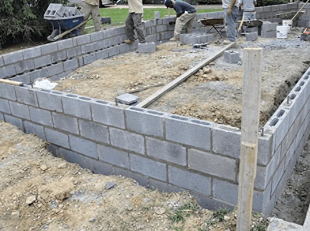 Professionals building a foundation with blocks in Houston, TX